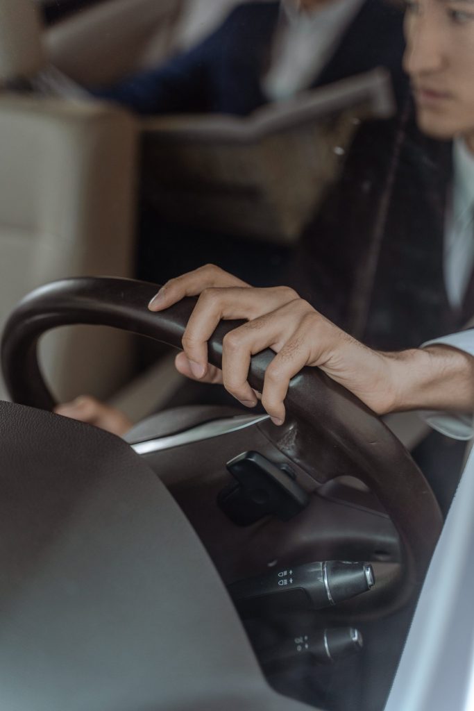 Person Holding Black Steering Wheel